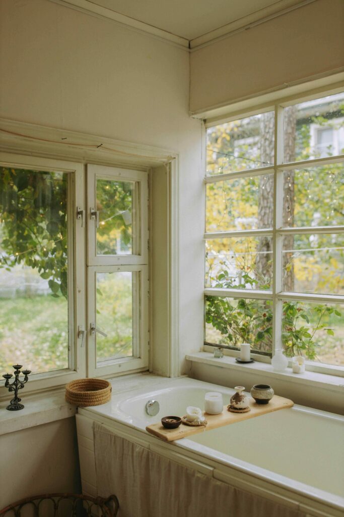 17 Cozy Bathroom Ideas to Create a Warm and Relaxing Retreat 9 Bright vintage bathroom with natural sunlight, classic details, and a relaxing soaking tub.