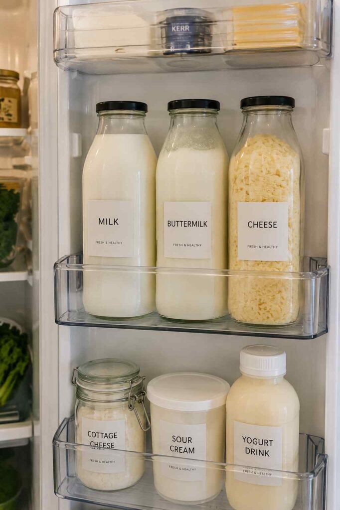 15 Smart Fridge Organization Ideas That Save Space and Reduce Food Waste 8 Refrigerator door organized with milk, yogurt, buttermilk, cheese, and dairy products grouped together in a dedicated dairy section.