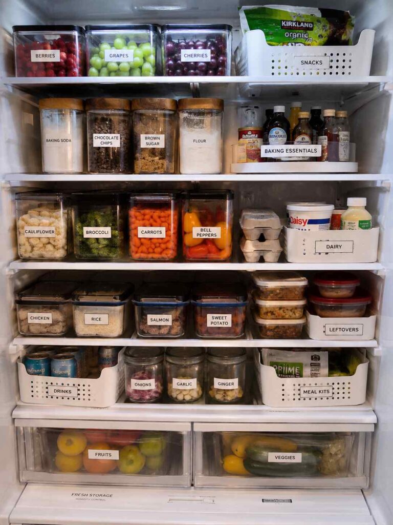 15 Smart Fridge Organization Ideas That Save Space and Reduce Food Waste 11 Organized refrigerator with labeled storage bins for dairy, snacks, produce, drinks, leftovers, and meal prep containers.